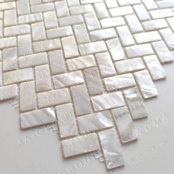 Close-up of a white mother of pearl kitchen backsplash tile showing its natural luster and shell texture.